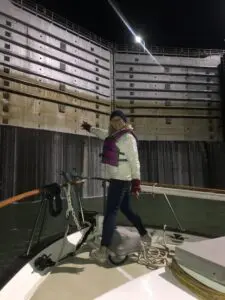 Person on boat inside ship lock at night